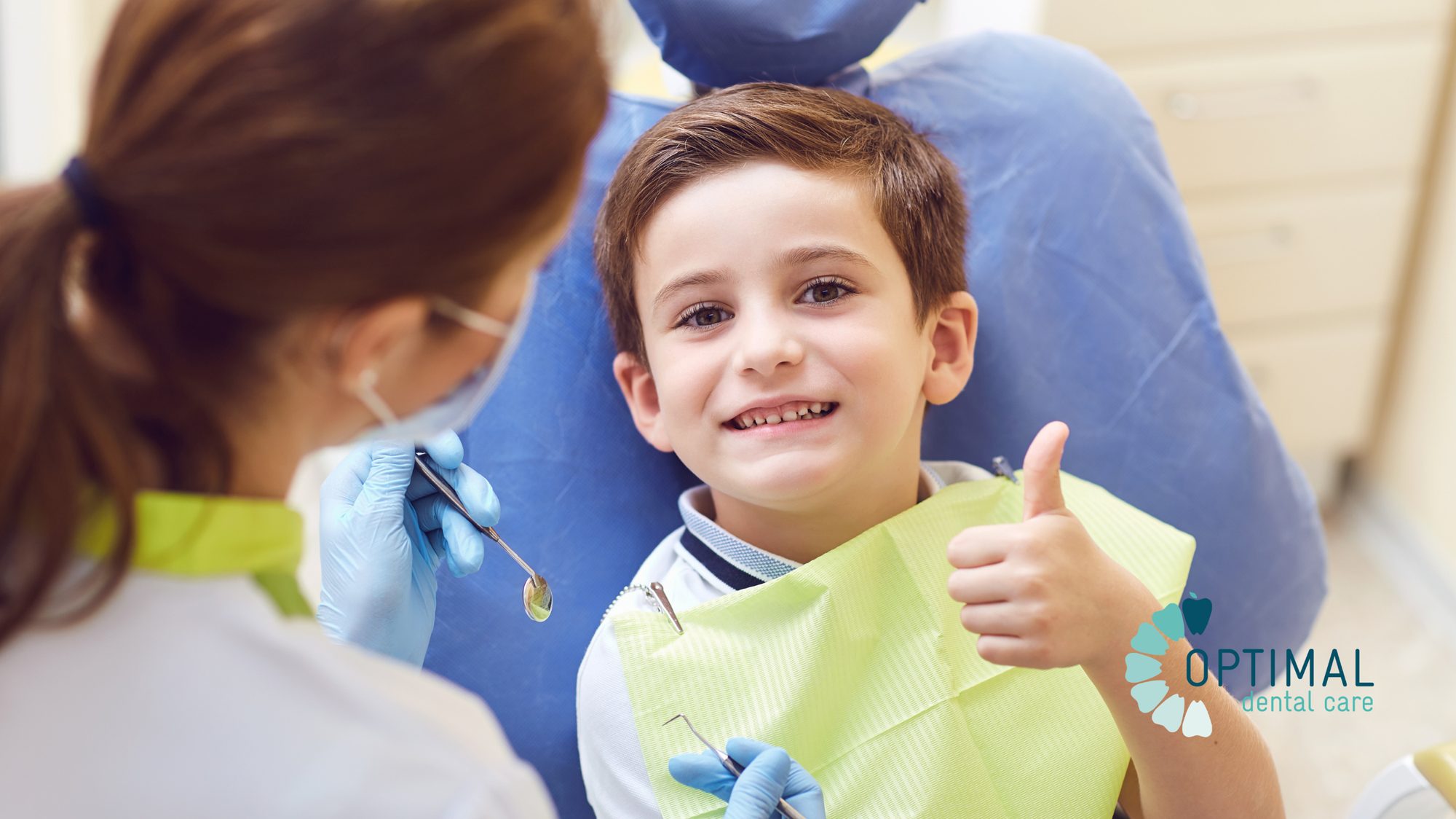 A smiling young patient giving a thumbs up in the dental chair during a check-up at Optimal Dental Care